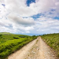 road through mountain meadows. beautiful landscape of Polonina Runa ridge on a cloudy summer day