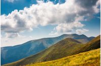 rolling hills of Borzhava mountain ridge in summer. wonderful nature background with grassy slopes under the cloudy sky