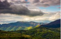 Rural area in mountains. Spectacular Carpathian mountain ridge in the distance on cloudy day