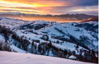 snowy mountainous countryside at sunrise. gorgeous landscape with snow covered hills. beautiful scenery in Carpathian mountains