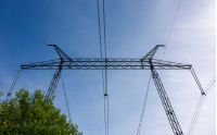 power line tower on a blue sky background. symbol of energy and power