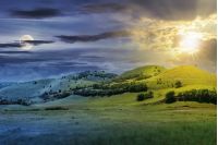 day and night time change concept above three hills in summer landscape. beautiful countryside scenery with sun and moon.  tilt-shift and motion blur effect applied.