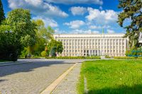 uzhhorod, ukraine - 06 may, 2017: government building of zakarpattia state administration. czechoslovakia architecture and cobblestone street of transcarpathia capital in evening light. narodna square