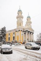 uzhhorod, ukraine - 12 jan, 2013: holy cross cathedral in winter. cloudy day, snowy weather. baroque church of 17s century