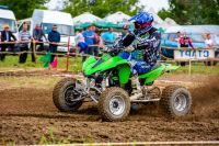 uzhhorod, ukraine - may 21, 2017: ATV rider accelerating on the dirt track. sport competition of green quad wheel vehicle in the mud