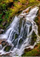 beautiful waterfall Shypot comes out of a rocky hillside in forest. spectacular landscape on mountain river view from the top. popular travel attraction in Ukrainian Carpathians.