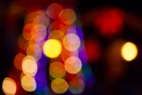 winter holiday colorful bokeh. festive decorated christmas tree lights on city street for beautiful new year abstract background. defocused red and yellow garlands for nostalgic moments atmosphere