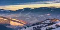 winter sunrise in mountains. beautiful carpathian wonderland. countryside with snow covered rolling hills. good morning wonderful nature