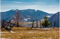 wooden fence on the edge of a hillside. beautiful countryside springtime landscape in mountains